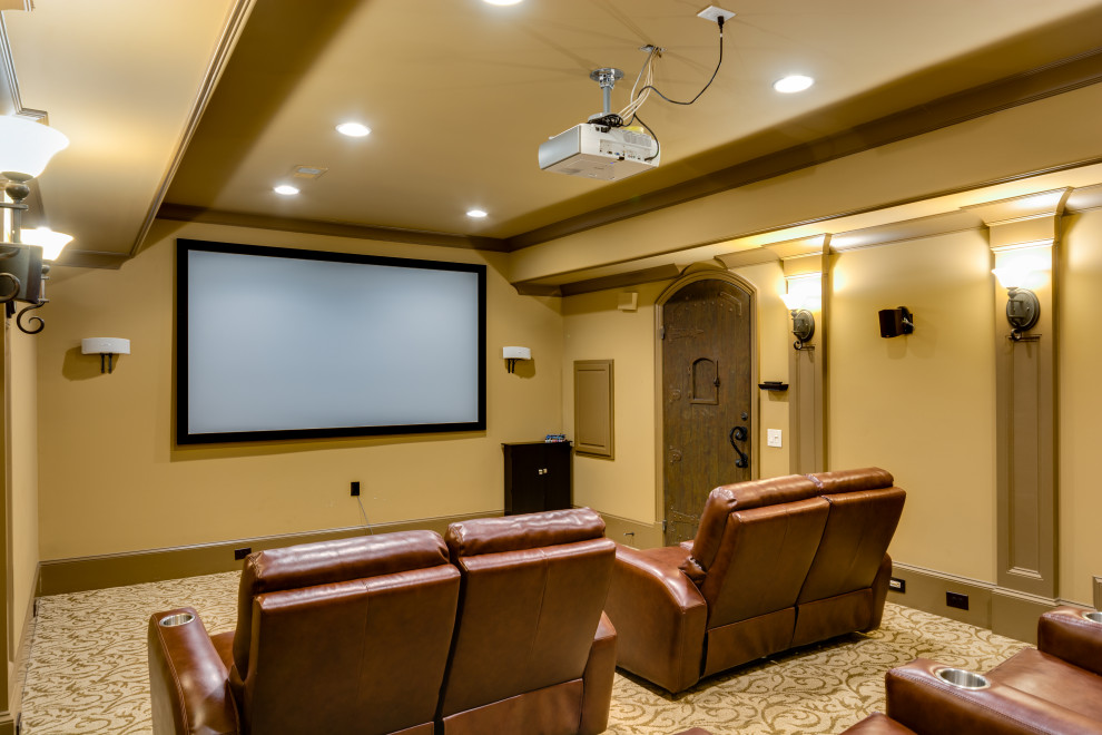 This is an example of a large home theatre in Atlanta with brown walls, carpet, a wall-mounted tv and multi-coloured floor.