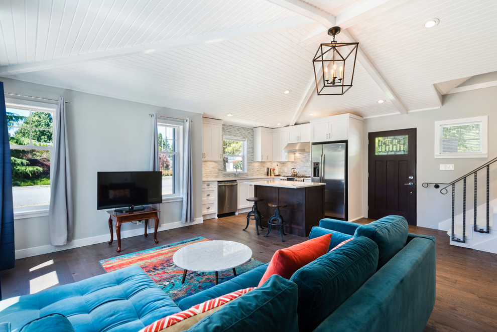 Example of a small transitional l-shaped medium tone wood floor and brown floor open concept kitchen design in Vancouver with an undermount sink, recessed-panel cabinets, white cabinets, quartzite countertops, gray backsplash, matchstick tile backsplash, stainless steel appliances and an island