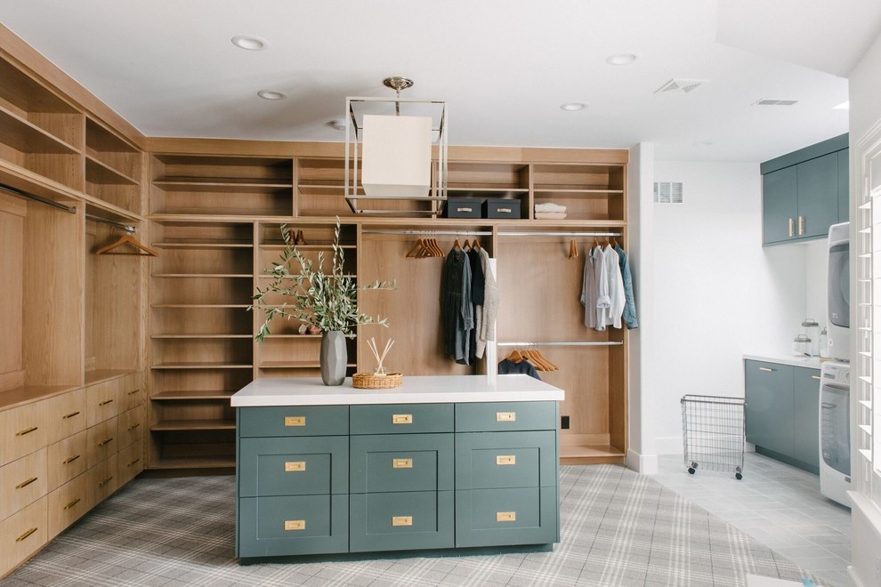 Large transitional gender-neutral dressing room in Salt Lake City with shaker cabinets, green cabinets, carpet and grey floor.