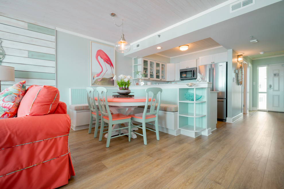 This is an example of a small beach style dining room in Wilmington with vinyl floors and yellow floor.