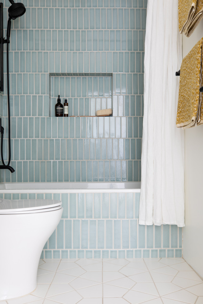 Inspiration for a small scandinavian bathroom in San Francisco with flat-panel cabinets, light wood cabinets, an alcove tub, an alcove shower, blue tile, ceramic tile, white walls, ceramic floors, an undermount sink, engineered quartz benchtops, black floor, white benchtops, a niche, a single vanity and a floating vanity.