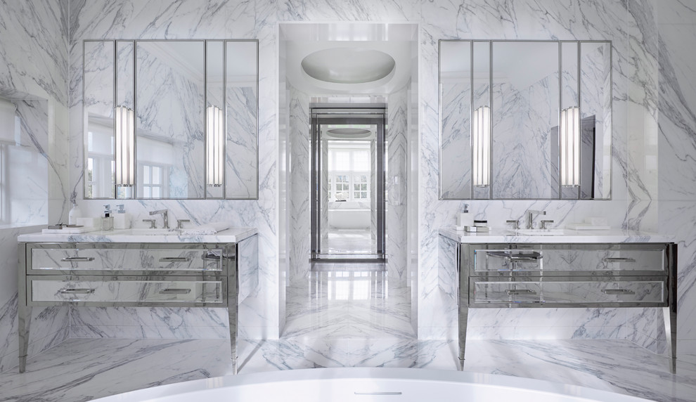 This is an example of a contemporary master bathroom in London with white tile, marble, white walls, marble floors, an undermount sink, white floor and flat-panel cabinets.