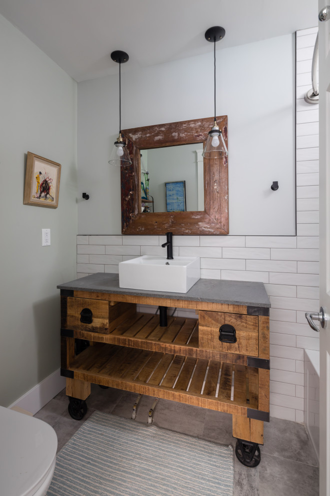 Design ideas for a mid-sized industrial powder room in Other with white tile, cement tile, white walls, cement tiles, a drop-in sink, grey floor, open cabinets, dark wood cabinets, concrete benchtops, grey benchtops and a freestanding vanity.