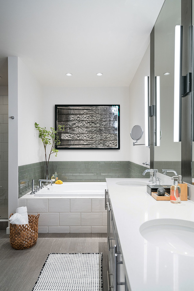 Photo of a mid-sized industrial master bathroom in Seattle with shaker cabinets, grey cabinets, a drop-in tub, green tile, cement tile, an undermount sink, engineered quartz benchtops and white benchtops.