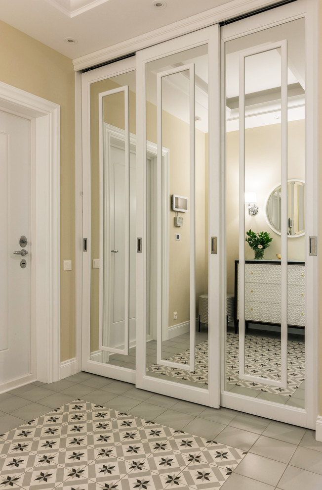 This is an example of a transitional entryway in Moscow with a single front door, a white front door, grey floor and beige walls.