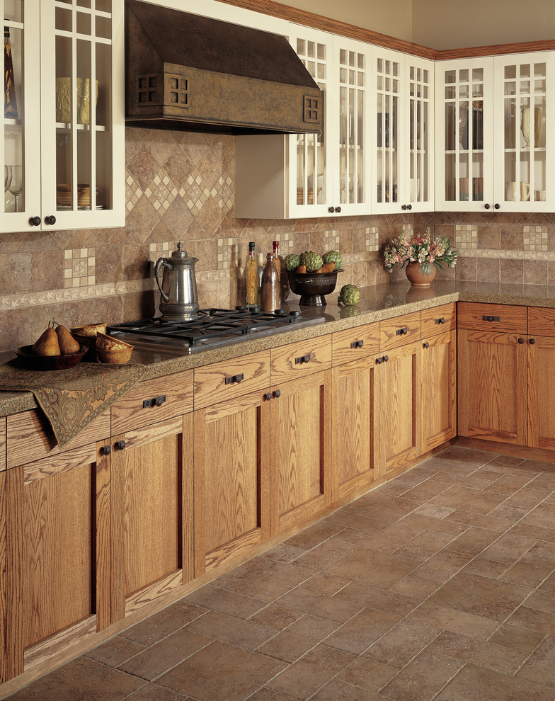 Inspiration for a mid-sized timeless l-shaped ceramic tile eat-in kitchen remodel in Manchester with light wood cabinets, granite countertops, beige backsplash, ceramic backsplash, stainless steel appliances and shaker cabinets