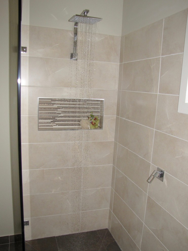 Mid-sized contemporary bathroom in Melbourne with shaker cabinets, beige cabinets, a freestanding tub, an open shower, beige tile, ceramic tile, beige walls, ceramic floors, a drop-in sink and laminate benchtops.