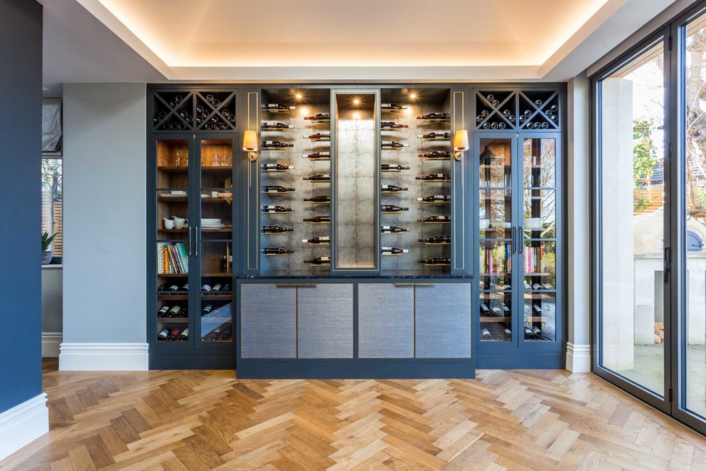 Large modern wine cellar in Other with medium hardwood floors, storage racks and brown floor.