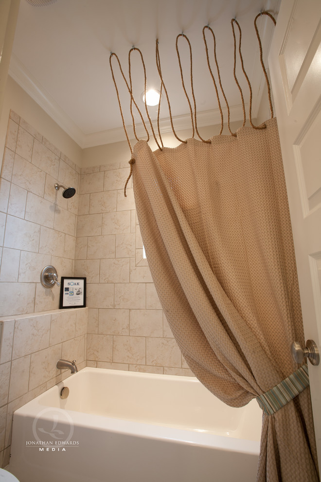 Mid-sized beach style kids bathroom in Other with an undermount sink, shaker cabinets, white cabinets, marble benchtops, a shower/bathtub combo, a two-piece toilet, beige tile, stone tile, beige walls and limestone floors.