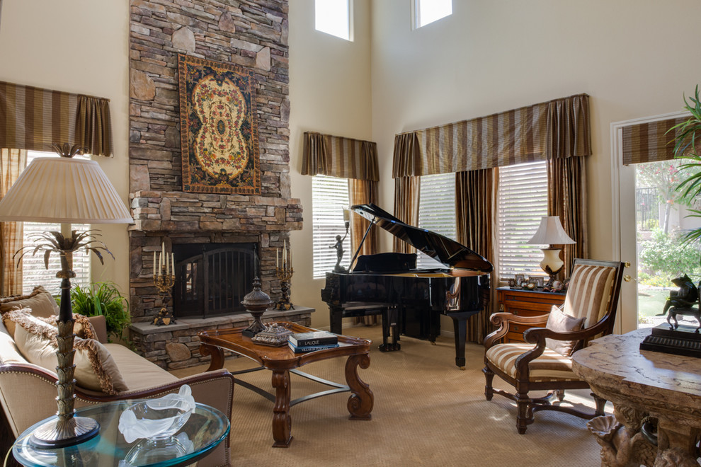 This is an example of a mid-sized traditional formal open concept living room in Las Vegas with beige walls, carpet, a standard fireplace, a stone fireplace surround and no tv.