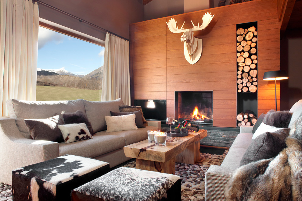 Design ideas for a mid-sized country formal open concept living room in Barcelona with brown walls, a standard fireplace and no tv.