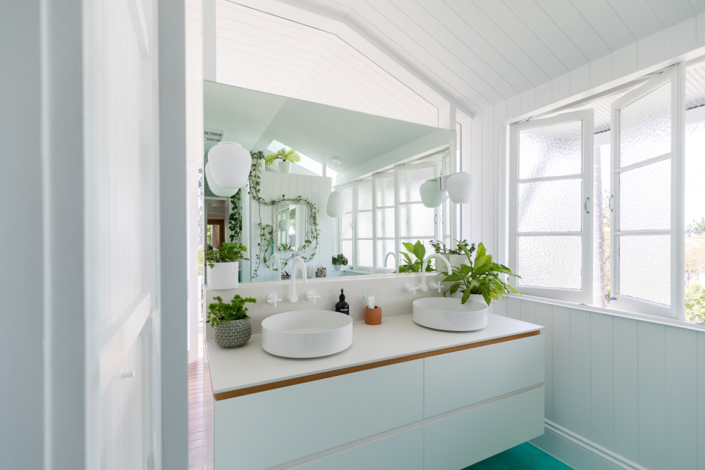Modernes Badezimmer mit weißen Fliesen, weißer Wandfarbe, türkisem Boden, weißer Waschtischplatte, Doppelwaschbecken und schwebendem Waschtisch in Brisbane
