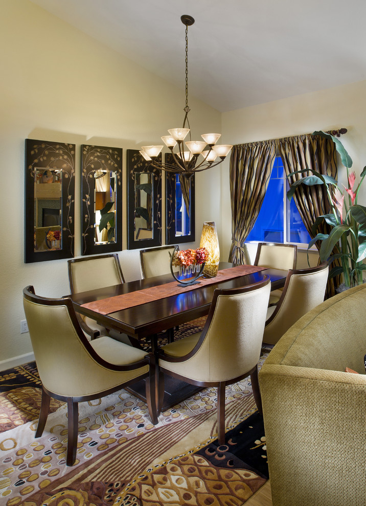 This is an example of a mid-sized eclectic dining room in Sacramento with beige walls, no fireplace and carpet.