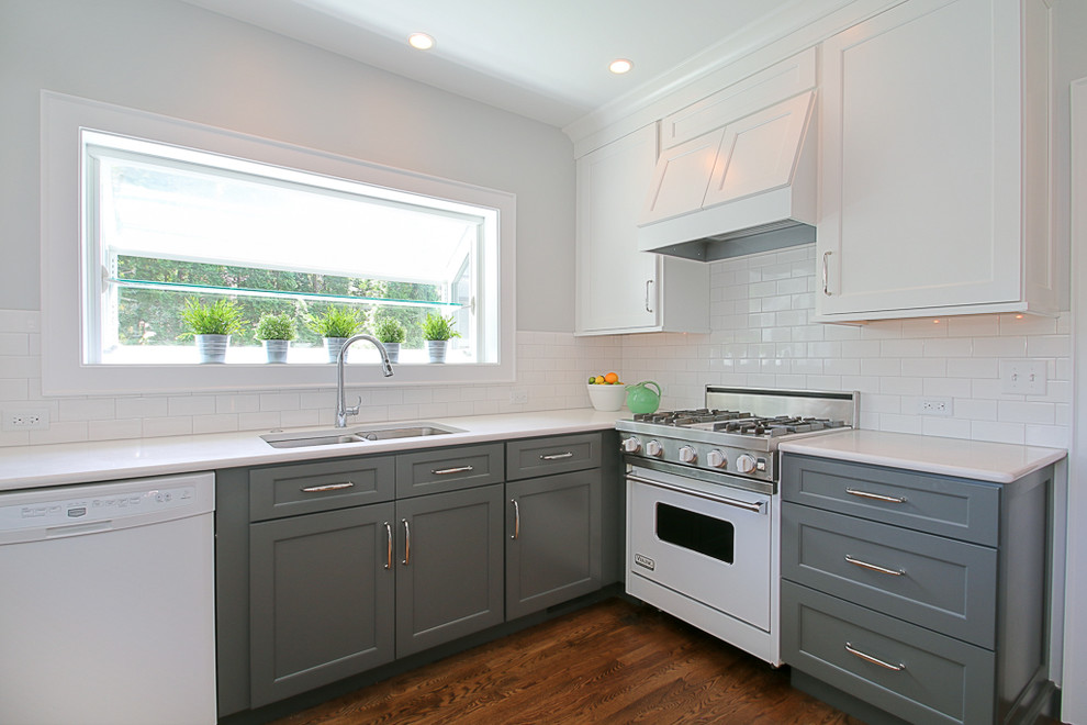 Inspiration for a small transitional u-shaped dark wood floor enclosed kitchen remodel in Chicago with an undermount sink, shaker cabinets, white cabinets, quartz countertops, white backsplash, subway tile backsplash, white appliances and no island