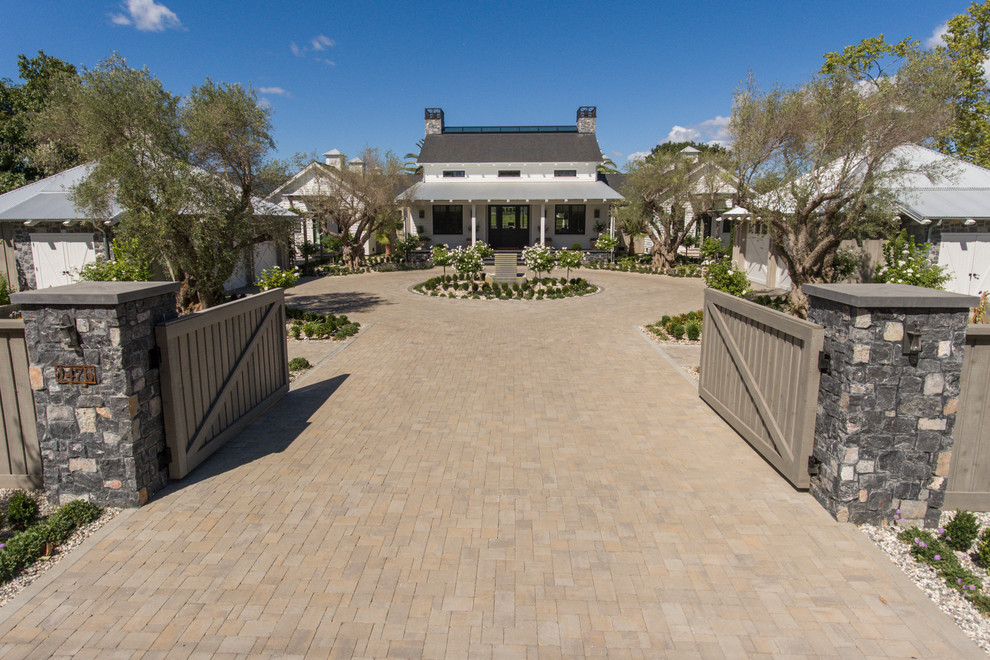 Design ideas for a large country courtyard full sun driveway for spring in San Francisco with a garden path and brick pavers.