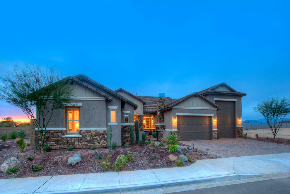 Inspiration for an expansive transitional one-storey adobe beige house exterior in Phoenix.