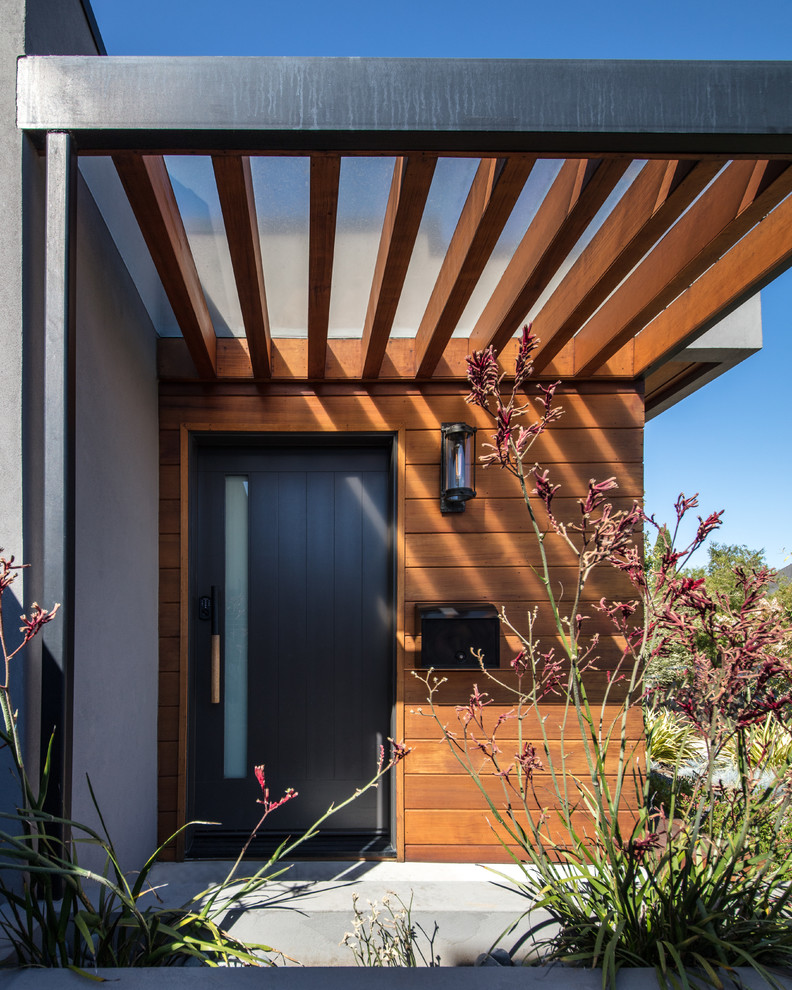 Photo of a contemporary entryway in San Francisco with a single front door and a black front door.