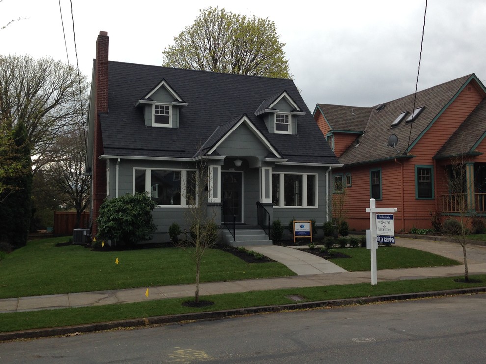This is an example of a mid-sized traditional two-storey grey exterior in Portland.
