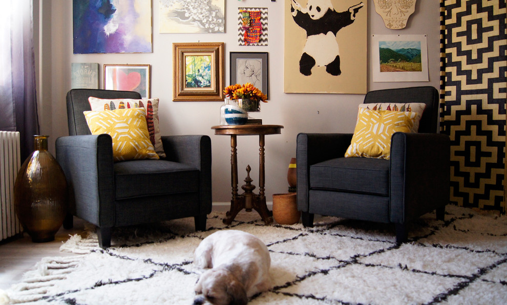 Inspiration for a small eclectic enclosed living room in New York with grey walls and no tv.