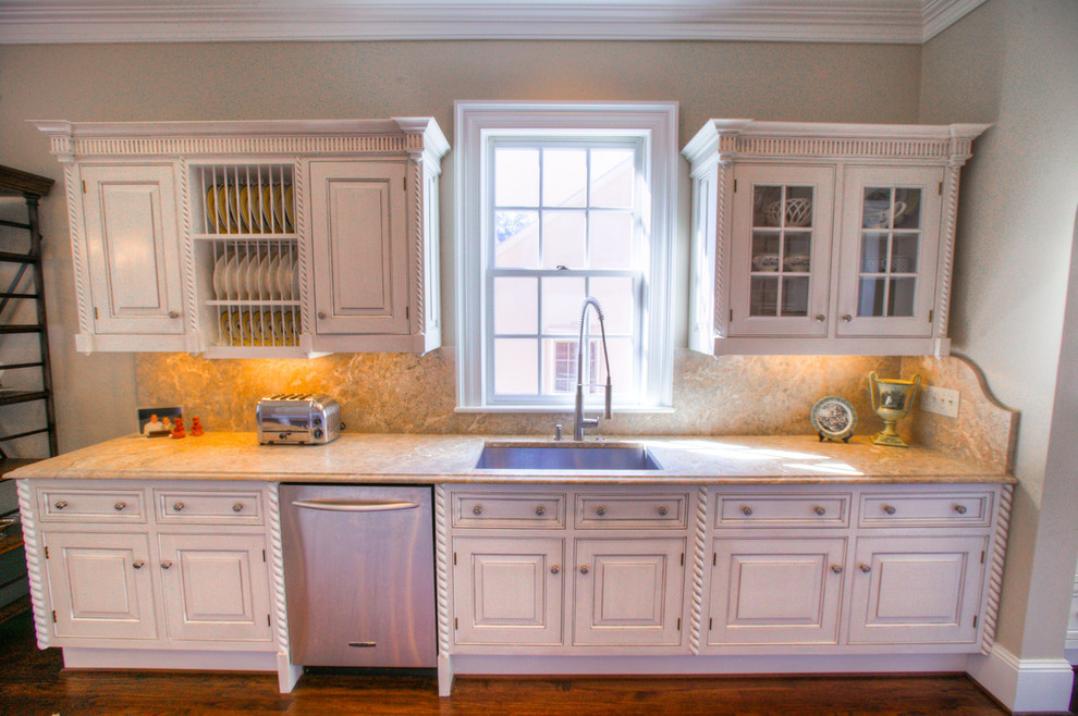 Eat-in kitchen - mid-sized transitional l-shaped medium tone wood floor eat-in kitchen idea in Charlotte with an island, an undermount sink, raised-panel cabinets, white cabinets, marble countertops, multicolored backsplash, stone slab backsplash and stainless steel appliances
