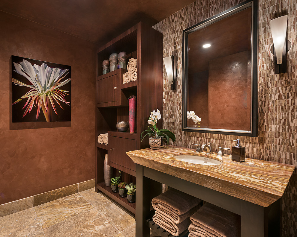 Photo of a large contemporary powder room in Other with stone tile, multi-coloured walls, travertine floors, an undermount sink, onyx benchtops, flat-panel cabinets, dark wood cabinets and multi-coloured tile.