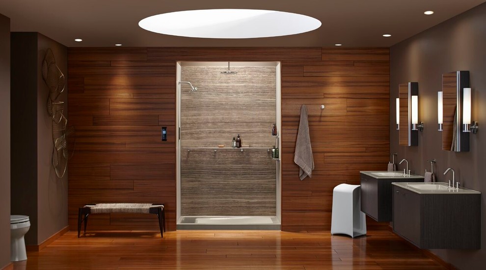 Design ideas for a large modern master bathroom in Albuquerque with flat-panel cabinets, dark wood cabinets, an alcove shower, a two-piece toilet, beige tile, brown tile, porcelain tile, brown walls, medium hardwood floors, an undermount sink, glass benchtops, brown floor and an open shower.