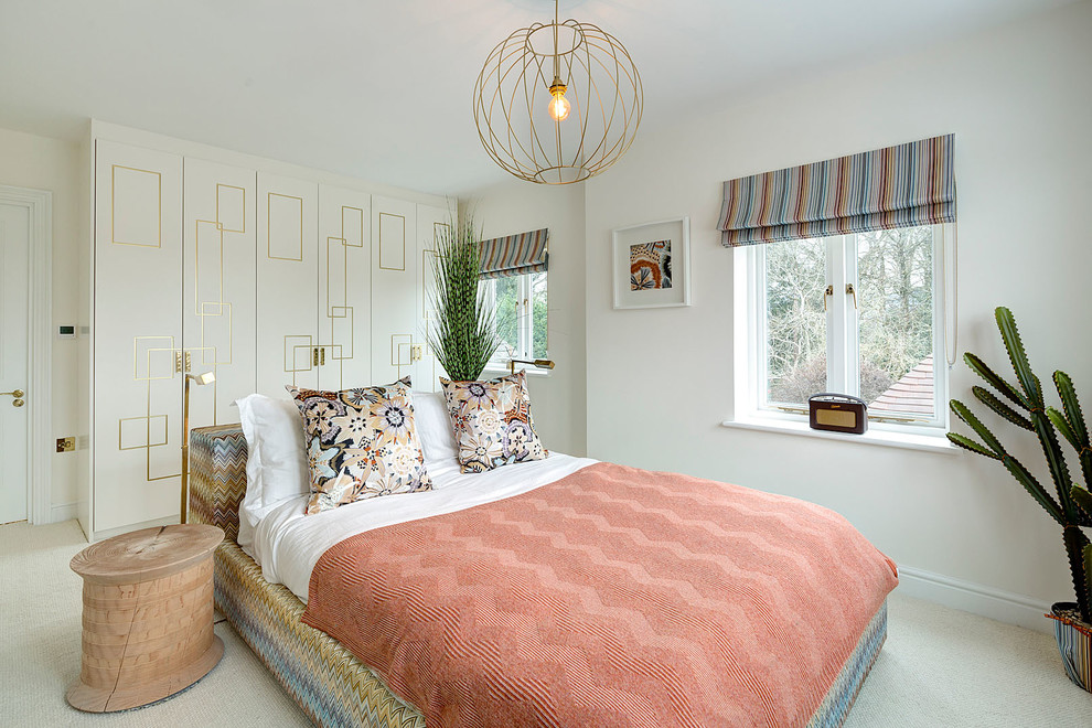 Inspiration for a mid-sized contemporary guest bedroom in Surrey with carpet and white walls.