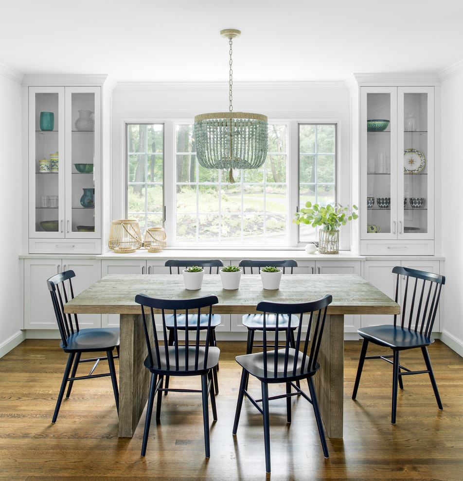 This is an example of a country separate dining room in Boston with white walls, dark hardwood floors and brown floor.