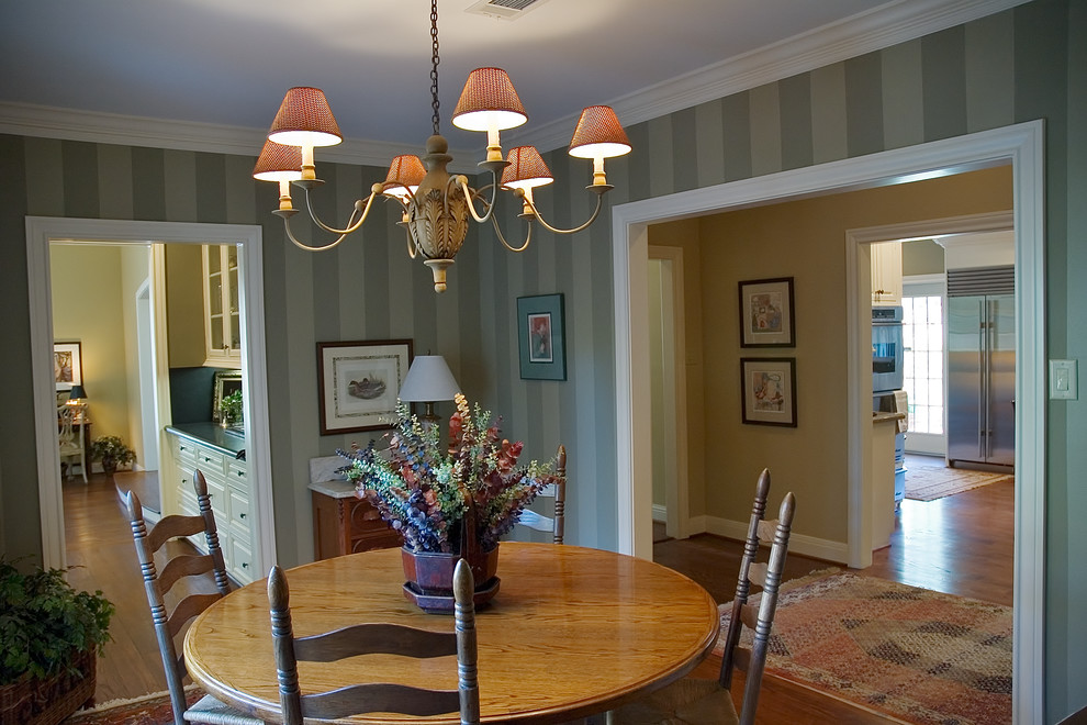 This is an example of a mid-sized traditional separate dining room in Houston with green walls and medium hardwood floors.
