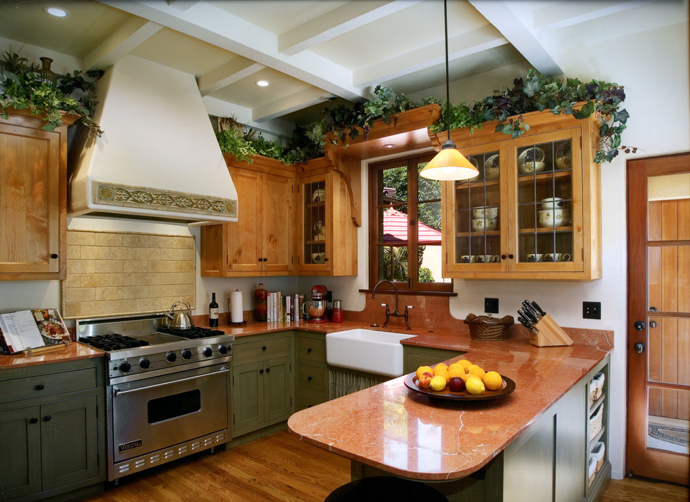 Photo of a mid-sized country l-shaped separate kitchen in Santa Barbara with a drop-in sink, glass-front cabinets, dark wood cabinets, limestone benchtops, yellow splashback, ceramic splashback, medium hardwood floors, with island and stainless steel appliances.