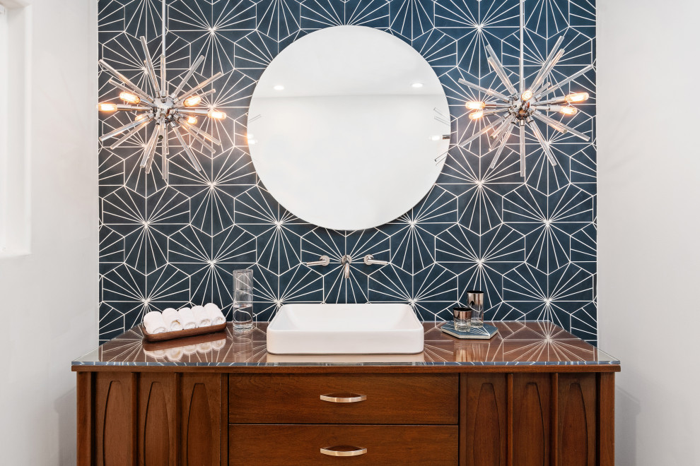 This is an example of an expansive midcentury bathroom in San Diego with furniture-like cabinets, dark wood cabinets, a one-piece toilet, blue tile, glass tile, blue walls, terrazzo floors, a vessel sink, glass benchtops, beige floor, a hinged shower door, white benchtops, a single vanity and a floating vanity.