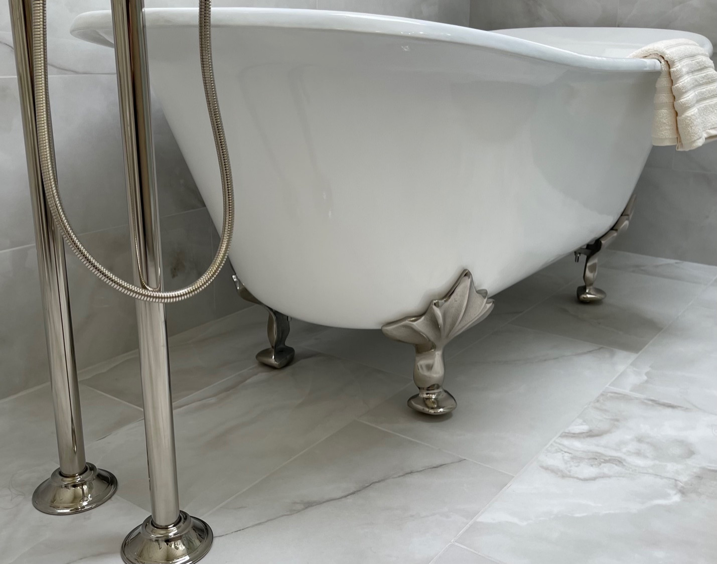 Porcelain floor & wall tile, freestanding sink, custom glass shower, custom window treatment, wallpaper, granite counter top, custom vanity