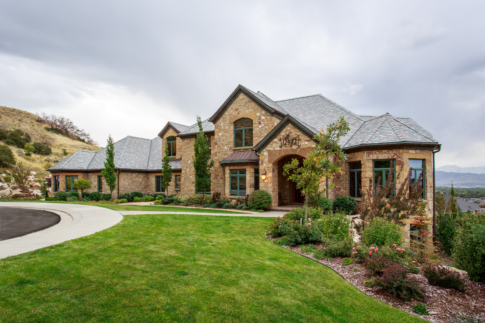 This is an example of a country two-storey exterior in Salt Lake City with stone veneer.