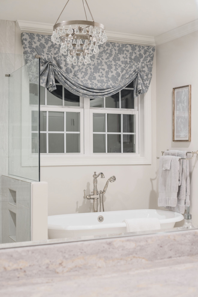 Design ideas for a traditional bathroom in Charlotte with raised-panel cabinets, white cabinets, a freestanding tub, a two-piece toilet, gray tile, grey walls, porcelain floors, an undermount sink, granite benchtops, white floor and white benchtops.