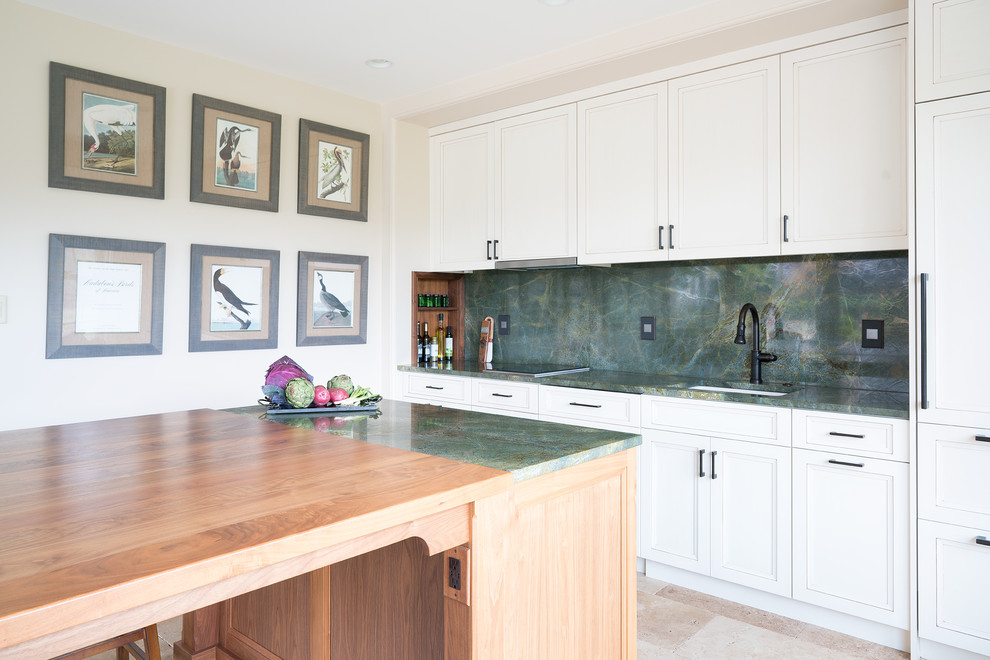 Mid-sized transitional single-wall open plan kitchen in Philadelphia with an undermount sink, white cabinets, quartzite benchtops, green splashback, stone slab splashback, panelled appliances, limestone floors and with island.