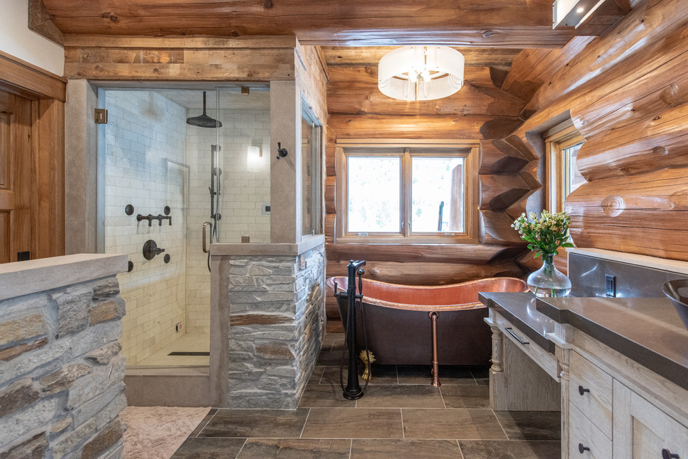 Country master bathroom in Salt Lake City with a claw-foot tub, a corner shower, white tile, subway tile, grey floor, a hinged shower door and grey benchtops.