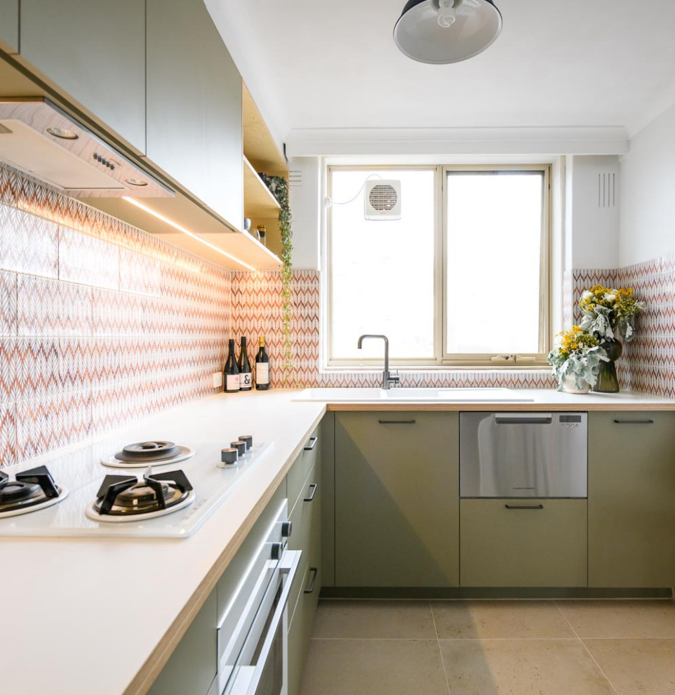 Photo of a small scandinavian l-shaped separate kitchen in Melbourne with a double-bowl sink, flat-panel cabinets, green cabinets, laminate benchtops, multi-coloured splashback, ceramic splashback, white appliances, ceramic floors, beige floor and white benchtop.