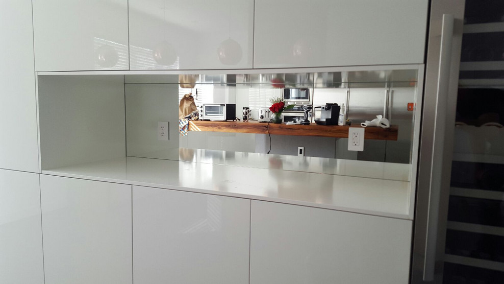 Design ideas for a large modern u-shaped kitchen in Miami with an undermount sink, flat-panel cabinets, white cabinets, wood benchtops, white splashback, stainless steel appliances, porcelain floors and with island.