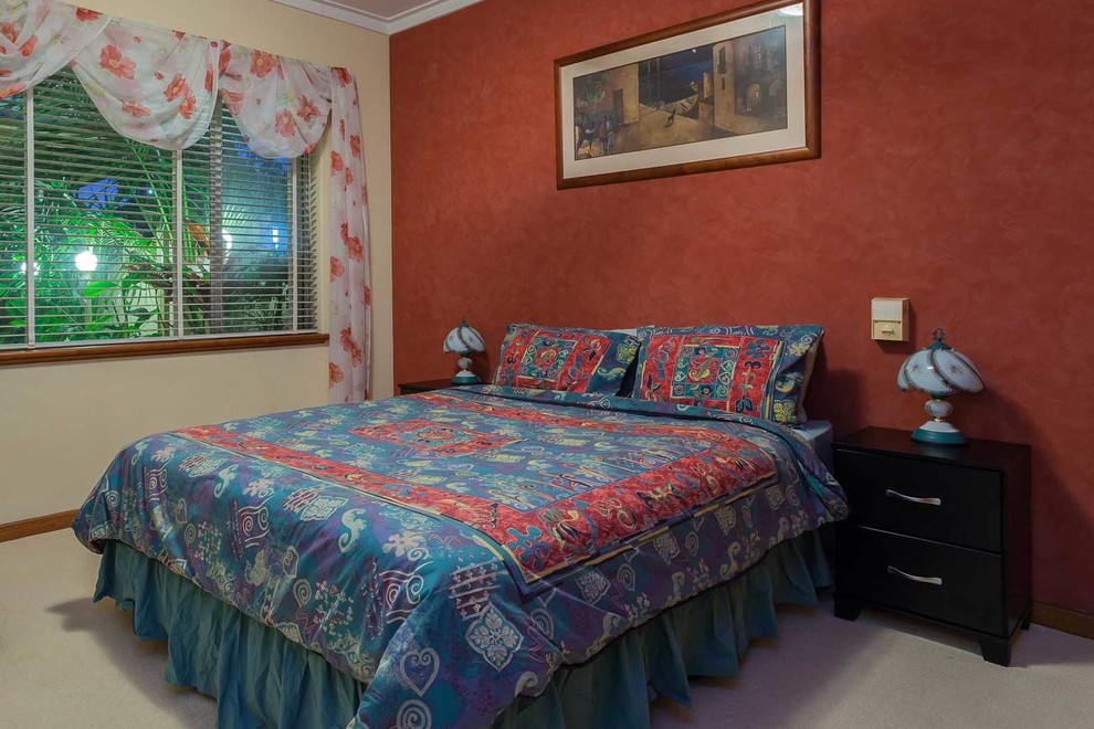 Large traditional guest bedroom in Perth with red walls, carpet and no fireplace.