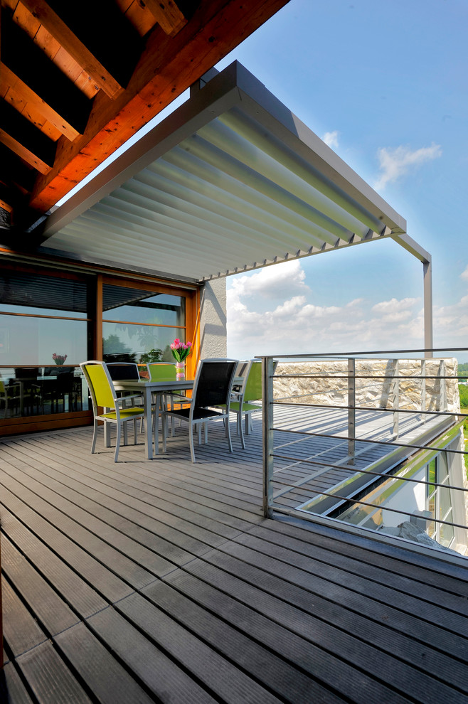 This is an example of a large contemporary rooftop and rooftop deck in Bologna with a pergola.