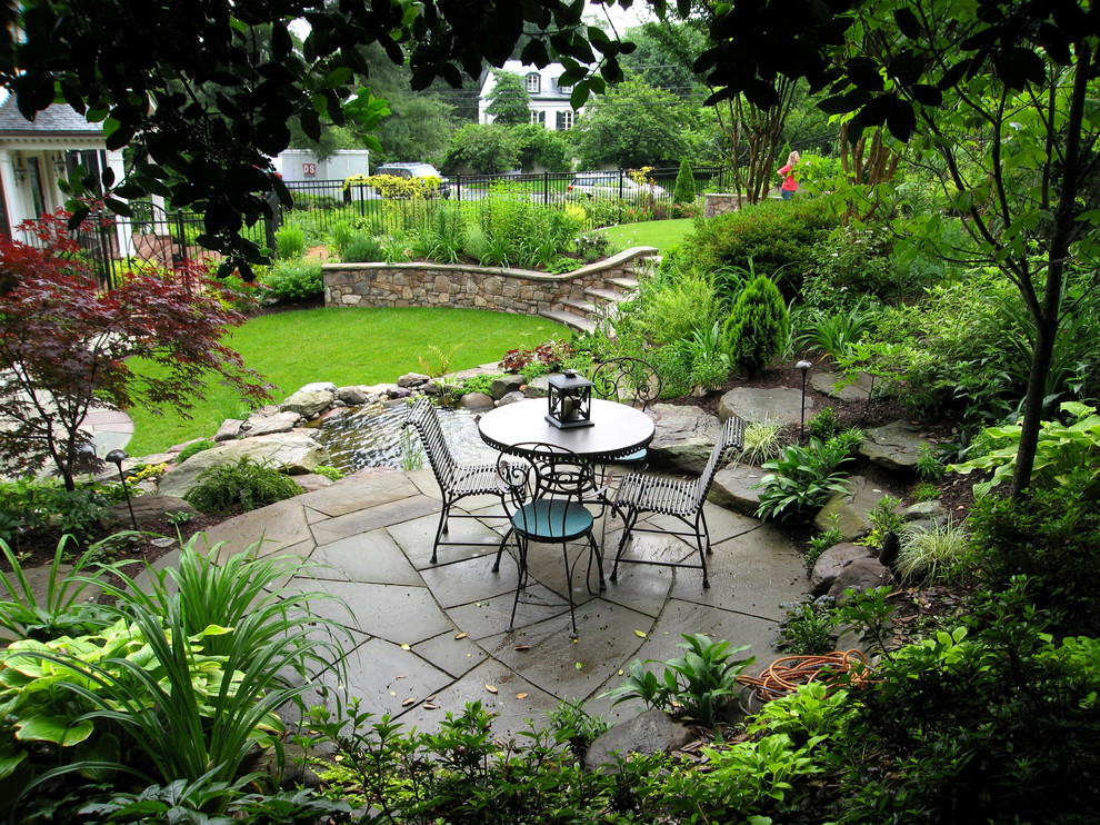 Large arts and crafts front yard garden in DC Metro with a water feature and natural stone pavers.