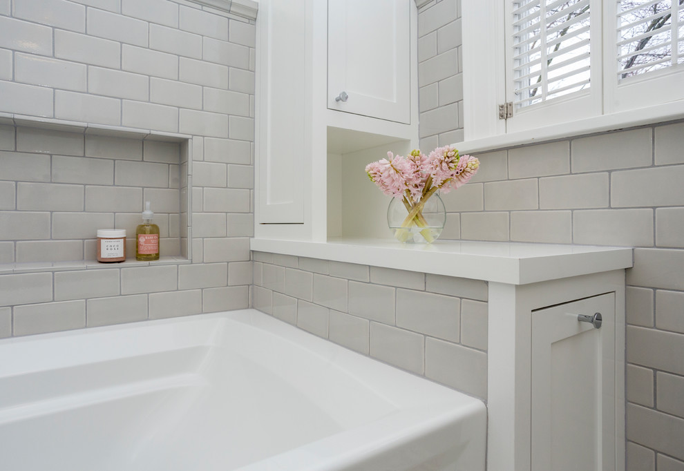 Photo of a mid-sized modern bathroom in Portland with recessed-panel cabinets, white cabinets, white tile, white walls, ceramic floors, multi-coloured floor, a hinged shower door, white benchtops, a corner tub, a corner shower, a two-piece toilet, ceramic tile, a pedestal sink and wood benchtops.