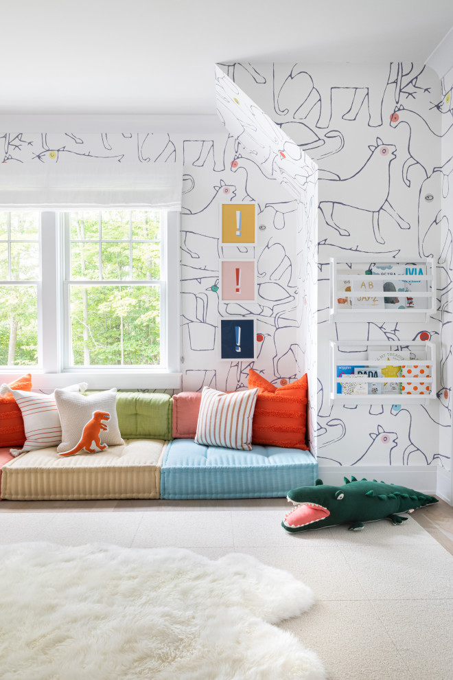 Mid-sized contemporary gender-neutral kids' playroom in New York with multi-coloured walls, light hardwood floors and brown floor for kids 4-10 years old.