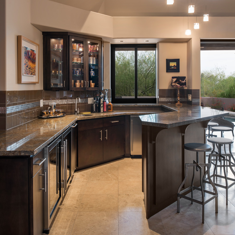 Inspiration for a home bar in Phoenix with an undermount sink, glass-front cabinets, dark wood cabinets, brown splashback, beige floor and brown benchtop.