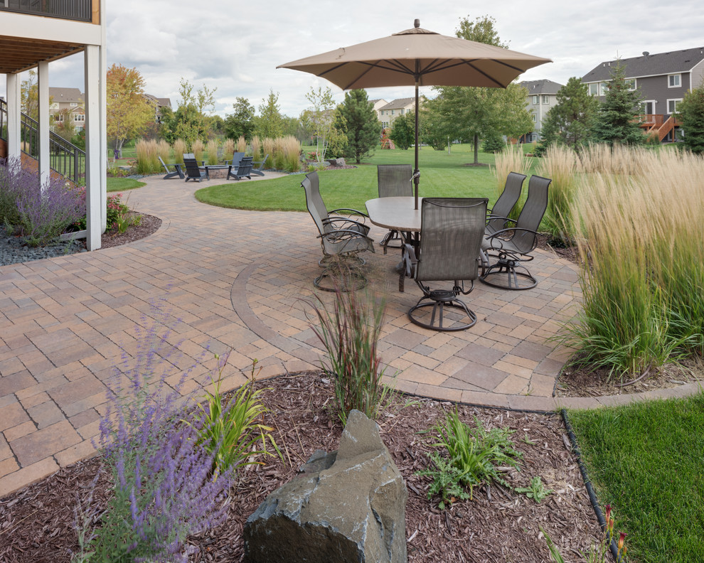 Design ideas for a mid-sized arts and crafts backyard patio in Minneapolis with concrete pavers.