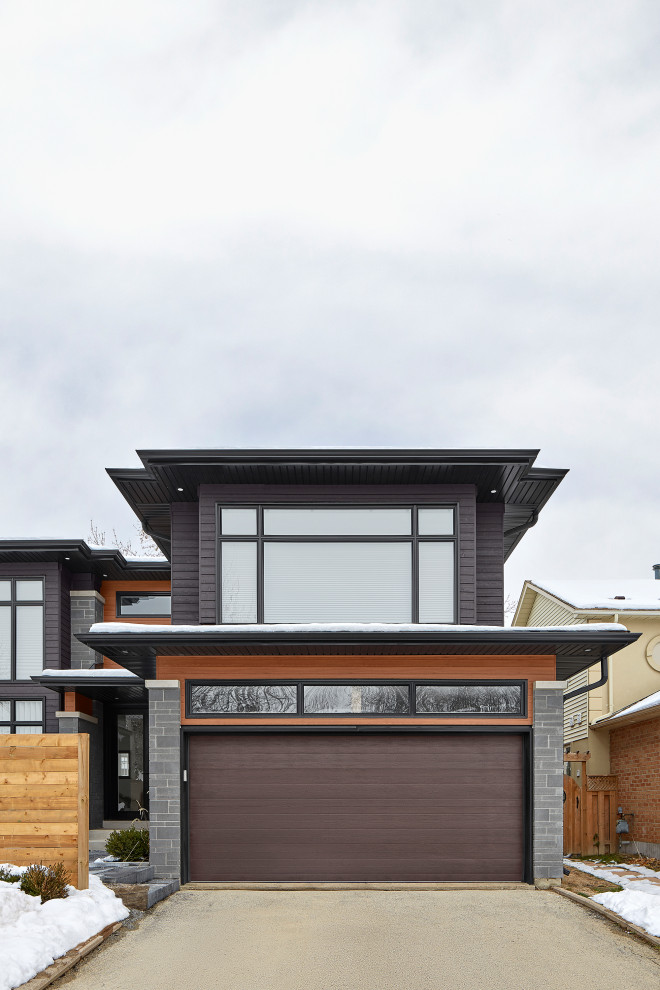Idées déco pour une façade de maison multicolore contemporaine en pierre et bardage à clin à un étage avec un toit en shingle et un toit gris.