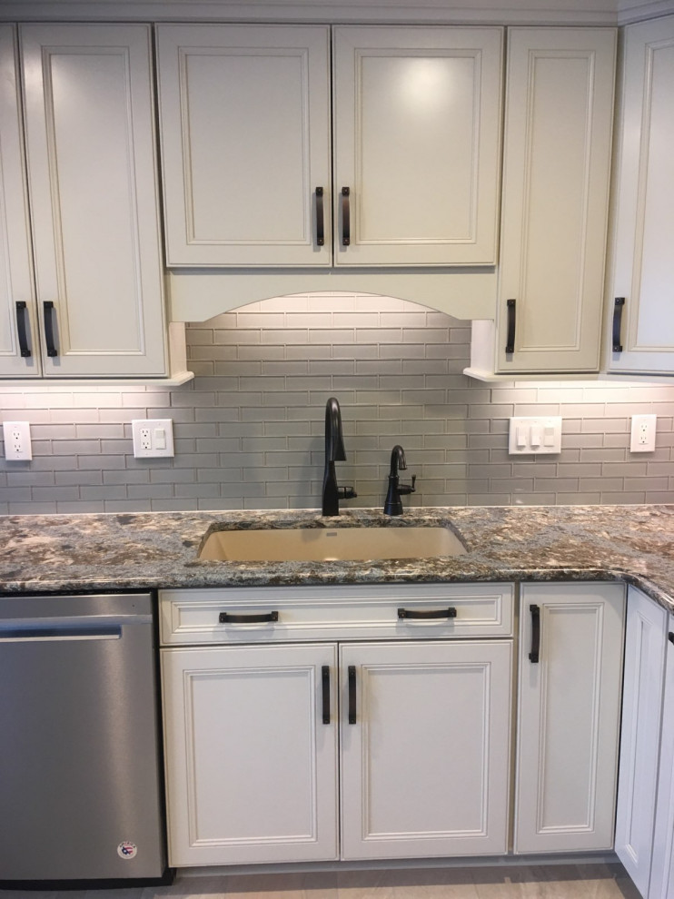 Transitional ceramic tile and gray floor kitchen photo with an undermount sink, recessed-panel cabinets, white cabinets, gray backsplash and stainless steel appliances