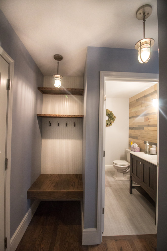 Photo of a small transitional hallway in Detroit with blue walls and dark hardwood floors.