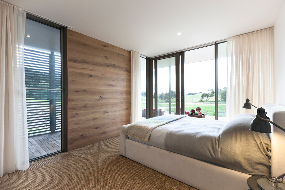 Country bedroom in Melbourne with light hardwood floors.