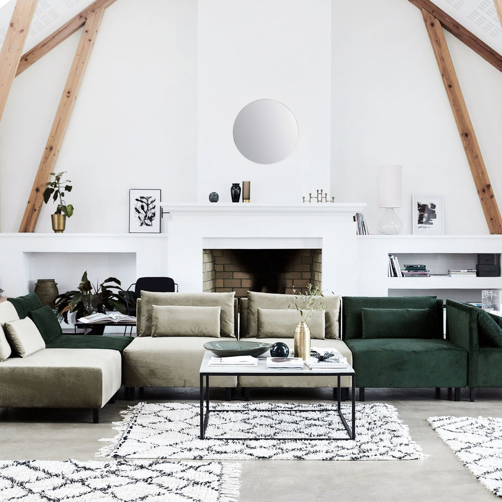 Design ideas for a large scandinavian open concept living room in Dresden with white walls, concrete floors, a standard fireplace and a brick fireplace surround.